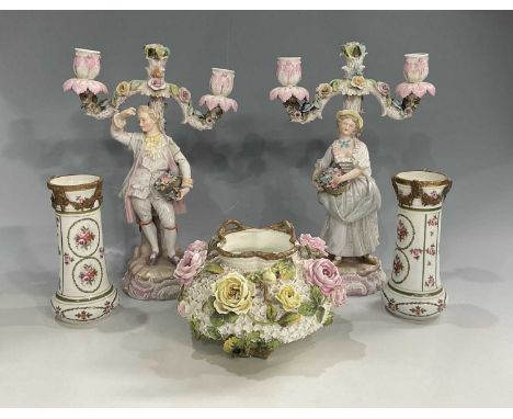 A pair of late 19th/early 20th century continental porcelain candelabra, two rotating branches, in the form of a lady and gen