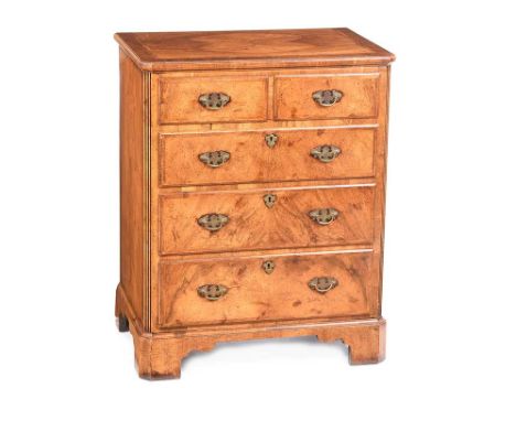 WALNUT TWO OVER THREE BACHELOR'S CHEST OF DRAWERS WITH BRASS DROP HANDLES.RAISED ON BRACKET FEET.HEIGHT: 32 INCHES.WIDTH: 26 