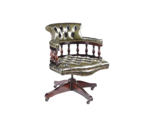 DEEP BUTTON GREEN LEATHER REVOLVING DESK CHAIR.RAISED ON A MAHOGANY BASE WITH CASTOR.HEIGHT: 33 INCHES.WIDTH: 24 INCHES.DEPTH