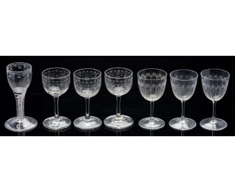 Two early 20th Century cut glass decanters and a range of drinking glasses. Including an air twist example together with a si