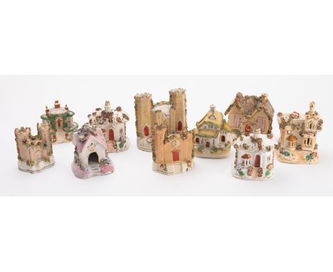 A collection of ten Staffordshire Pastel burners. In the form of houses including thatched examples, all encrusted with flora