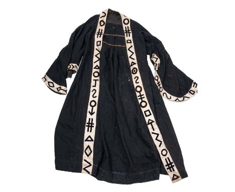 A black wool masonic style cloak, trimmed with white silk embellished with stylised symbols, together with a red wool bolero 