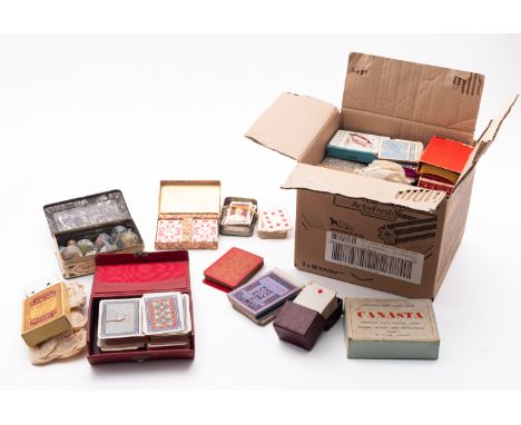A collection of glass marbles with a selection of playing card sets and part sets.