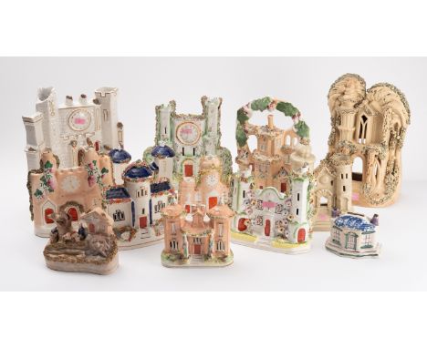 A collection of Staffordshire pastel burners, comprising mainly houses including three clock towers in a range of colours and
