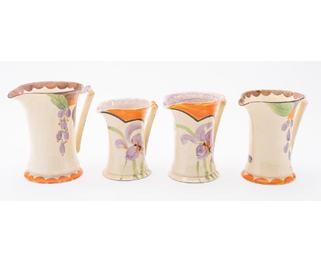 Four Myott pottery jugs of waisted form each painted with stylised blooms, printed gold marks, tallest 18cm high.


