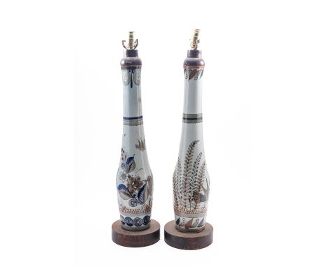A pair of ceramic table lamps. Having floral and bird decoration with wooden bases and rims, 79cm high excluding shades.