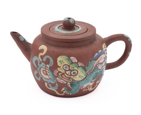 An Yixing stoneware tea pot, liner and cover with polychrome enamel decoration in the form of a lion dog, 19cm long.


