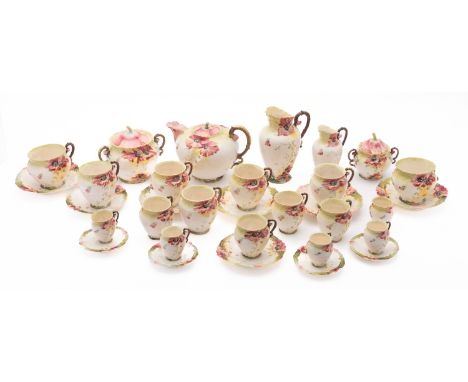 A Carl Knoll Art Nouveau tea coffee set. having floral decoration on a green and white ground, comprising a teapot, two lidde