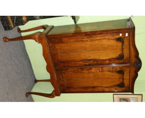 A 19th century Dutch walnut cabinet on later stand, the arched cresting centred by a carved putti mask in cartouche over two 
