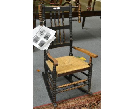 A 19th century oak framed bobbin turned Eskdale winged rocking armchair, rush seat 