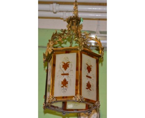 A hexagonal glass and brass hall lantern