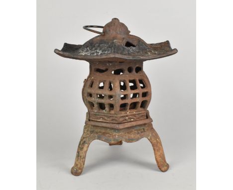 A Cast Metal Lantern in the Form of a Pagoda, 26cms High