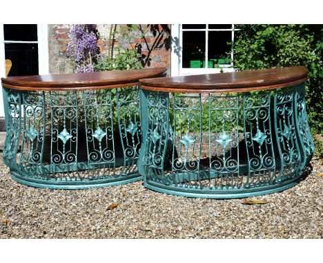 A pair of painted wrought iron balcony guards, circa 1900, of demi-lune form, later reconditioned and adapted as console tabl