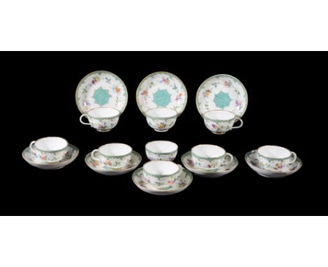 Eight Meissen (Punkt) teacups and saucers, circa 1770, painted with flowers within rococo borders, blue crossed swords and do