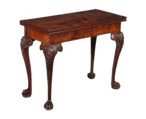 A George II mahogany card table, circa 1740, possibly Irish, the folding top opening to baize inset and corner wells, 73cm hi