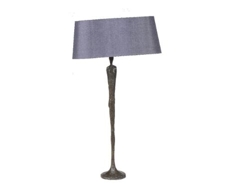 A bronzed table lamp in the form of a stylised standing figure, modern, 65cm high excluding fitments, a circular low occasion