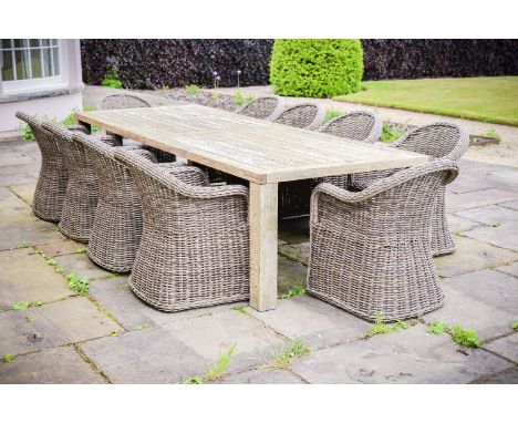 A teak garden table and ten faux wicker chairs, retailed by GLOSTER, of recent manufacture, table of rectangular form and cha