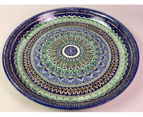 LARGE CERAMIC PLATE, ALONG WITH OTHER DISHES the large plate in green, blue and brown large plate 45cm diameter 