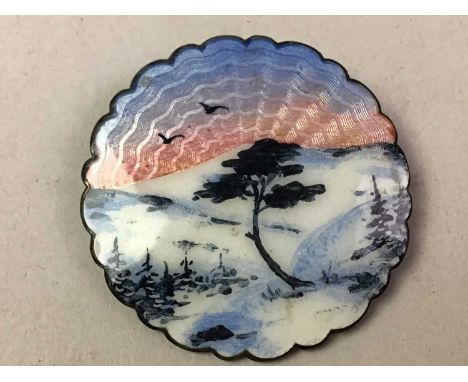 IVAR HOLTH, TWO NORWEGIAN SILVER AND ENAMEL BROOCHES one of shaped circular form, enamel decorated with trees in a mountaineo
