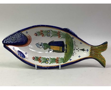 HENRIOT QUIMPER FISH DISH, the dish shaped as a fish, decorated with a figure in a naturalistic setting26cm long