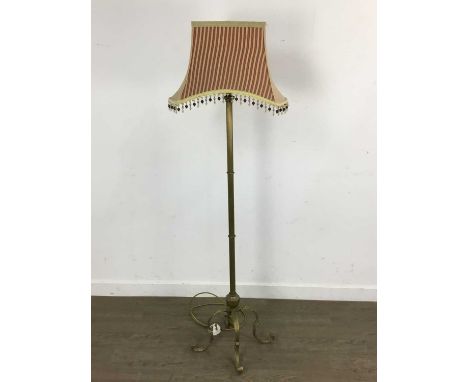 BRASS COLUMN STANDARD LAMP AND SHADE, on four scrolling legs