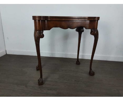 WALNUT CARD TABLE, 20TH CENTURY the green baize card table on tapered supports and ball and claw feet75cm high, 76cm wide