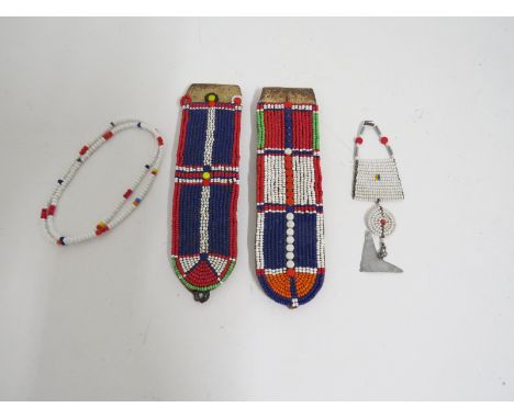 A pair of Indigenous American beaded epaulettes and three pieces of beaded and metal necklaces  