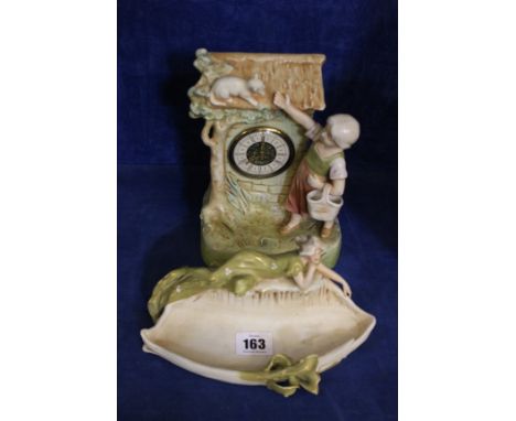A Royal Dux Bohemia mantel clock, decorated with child and cat, 19.5cm high and a Royal Dux dish decorated with reclining lad