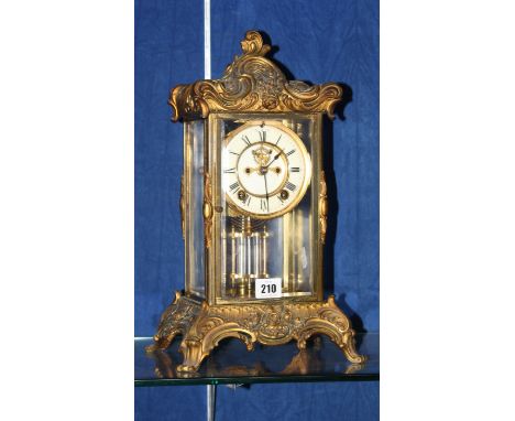 A 19th Century glass cased and gold ormolu mounted mantel clock, 38cm high