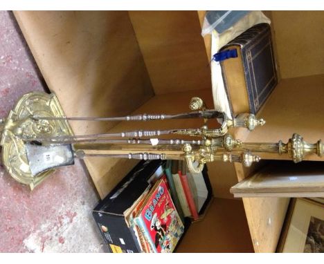 A brass stick stand and a set of brass and steel fire irons, comprising poker, tongs and shovel