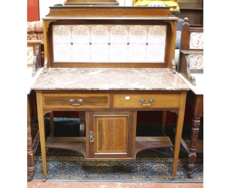 A late Victorian mahogany and crossbanded marble top washstand with a tile back 108cm wide