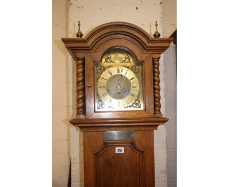 A 20th Century oak longcase clock Tempus Fugit with a brass dial and silent chime, bearing plaque 'deja vu' 