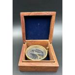 A vintage wooden cased brass compass, the box featuring a brass star inlay