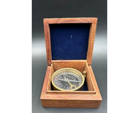 A vintage wooden cased brass compass, the box featuring a brass star inlay 