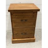 A pine two door side cabinet, the deep drawers for files of other items (H78cm W53cm D46cm)