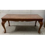A carved walnut glass topped coffee table (H48cm W104cm D50cm)