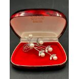A pearl and silver brooch