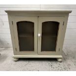 A glazed painted side cabinet on bun feet AF (H76cm W80cm D25cm)