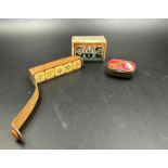 A selection of curios to include a WWII commemorative match box cover, a vintage HMV record needle