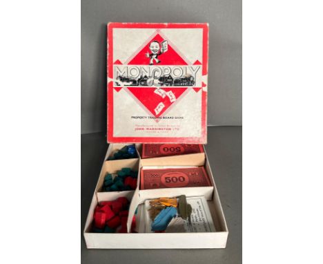 A vintage Waddington's Monopoly set with metal pieces 