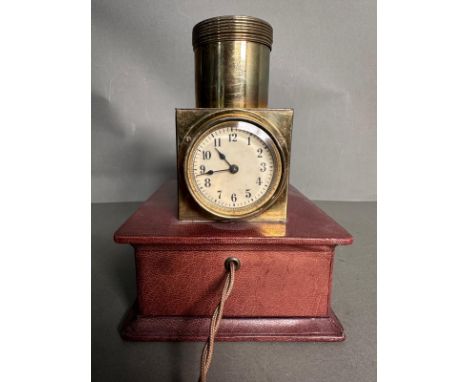 An Edwardian Ceiling projector clock or brothel clock, the circular dial with Roman numerals in a brown leather case