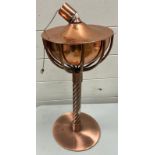 A copper bowl oil burning torch