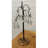 A tee light table stand with glass tear drop holders