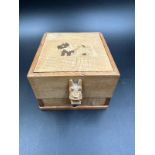 A vintage wooden Scottie dog cigarette dispenser