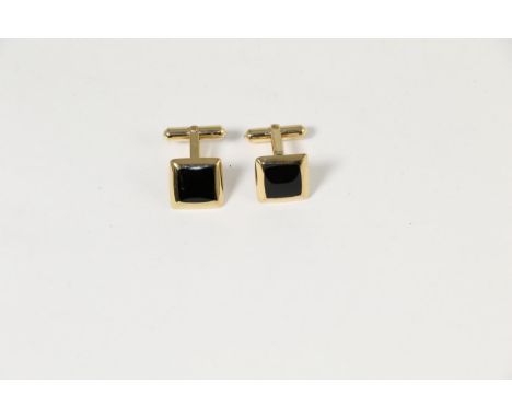 A pair of 9 carat gold onyx cufflinks, square onyx plaques to rounded frames, with swivel backs .  12.2g