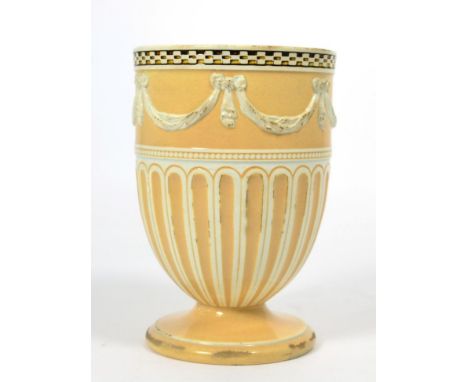 A Wedgwood creamware urn shaped vase, late 18th century, moulded with drapery swags within engine turned and gadrooned border