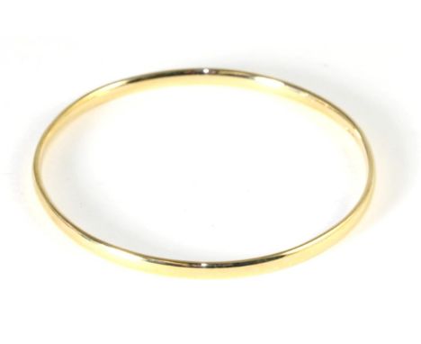 A 9 carat gold bangle, measures 6.5cm in diameter .  16.6g
