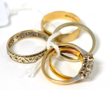 An 18 carat white gold ring, 22 carat gold band ring, 9 carat gold band ring and two other rings