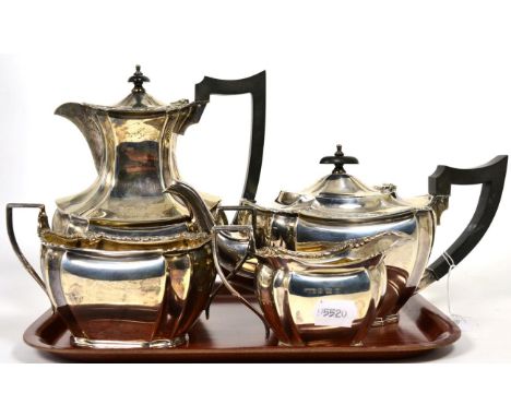 A four-piece silver tea service, Daniel & Arter, Birmingham, 1934, shaped oval with foliate rim, of heavy gauge, the hot wate