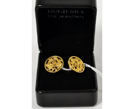 A pair of Chinese cufflinks, pierced circular plaques with a dragon motif, to swivel bars, stamped '585'.  6.5g